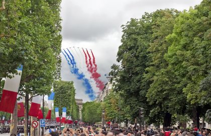 PARIS - JULY 14: People are watching French Patrouille de France at a military parade in the Republic Day (Bastille Day) on Champs Elysees in Paris, France on July 14, 2012.